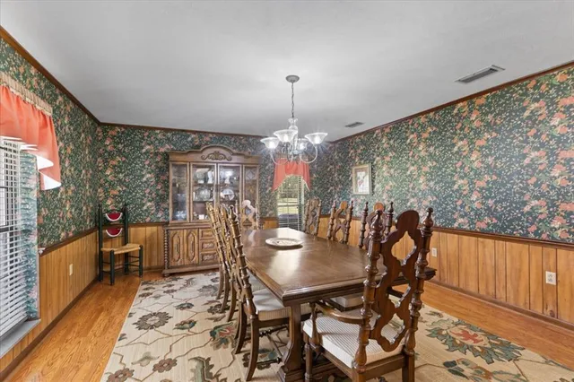 a view of a dining room with furniture and chandelier