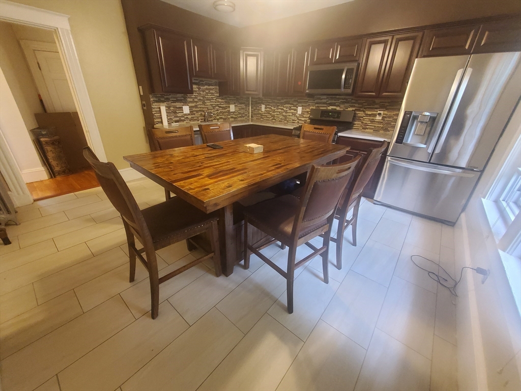 45 Intervale Street, Unit 2 Boston, MA 02121 - Photo 4 of 17 a view of a kitchen with granite countertop stainless steel appliances and a sink