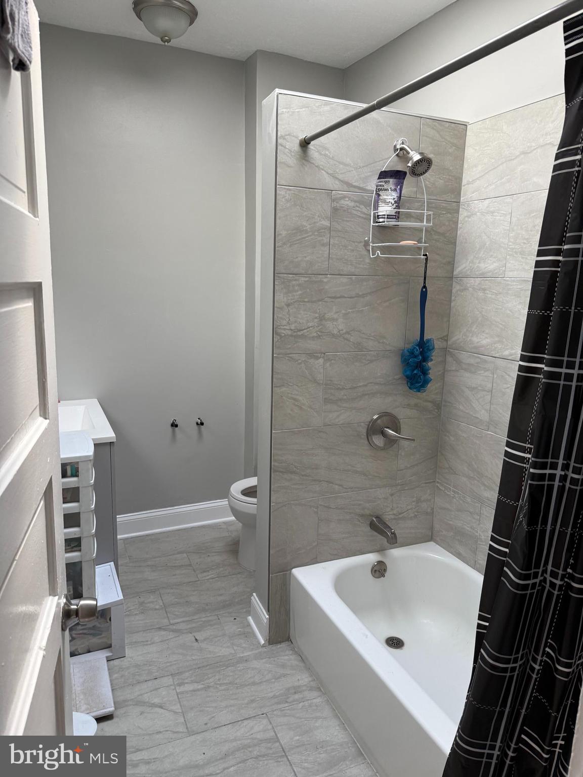 2921 Baker Street Baltimore, MD 21216 - Photo 2 of 7 a bathroom with a sink a toilet and shower