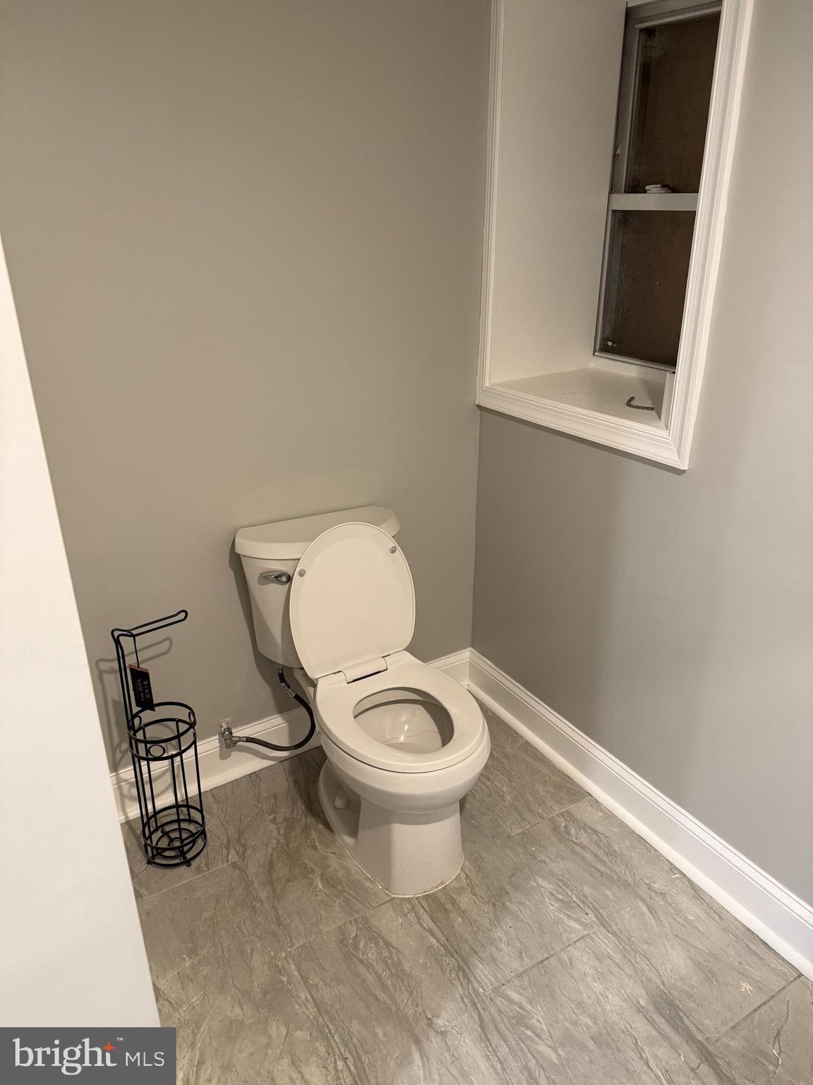 2921 Baker Street Baltimore, MD 21216 - Photo 7 of 7 a white toilet sitting next to a bathroom sink