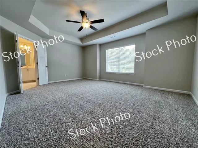 a view of a hallway with a ceiling fan