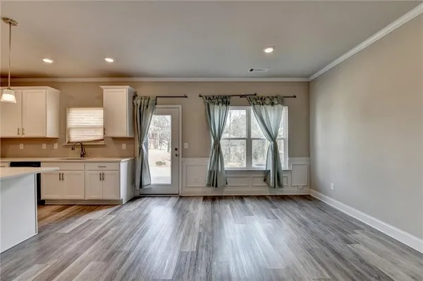 a kitchen with a refrigerator and white cabinets