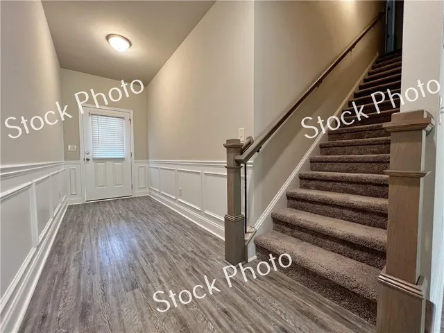 a view of entryway and hall with wooden floor