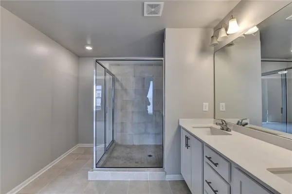 a bathroom with a shower and a sink