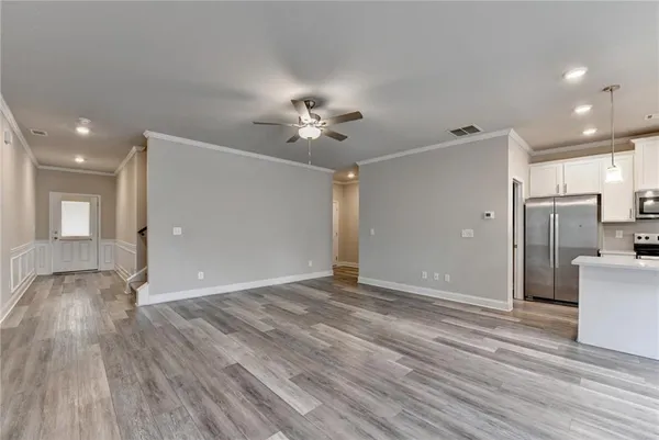 a view of an empty room with a kitchen