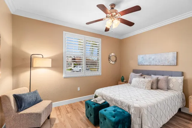 a view of a hallway with wooden floor and a living room