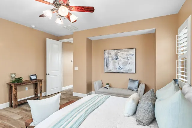 a bedroom with furniture and a large window