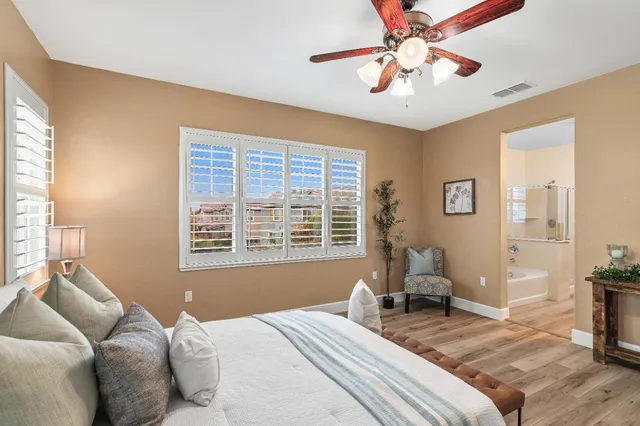 a bedroom with a bed and a painting on the wall