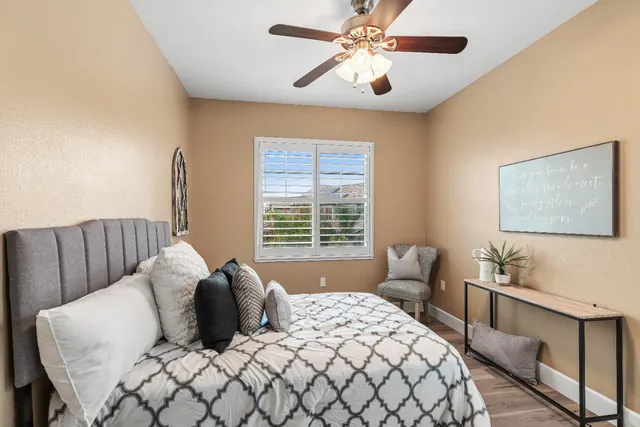 a view of a backyard with table and chairs with wooden fence