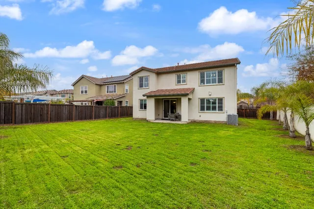 an aerial view of a house with a garden and lake view