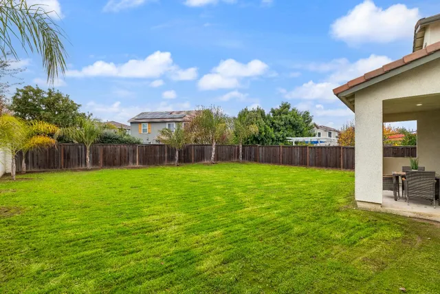 a view of a swimming pool with a lawn chairs under an umbrella