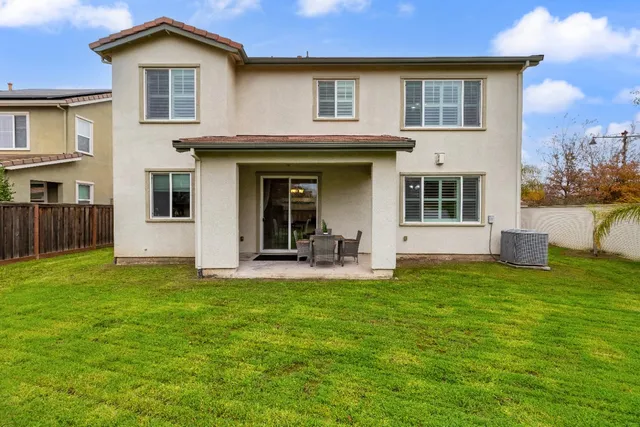 a view of a swimming pool with a patio and a garden