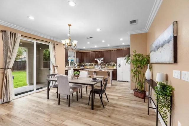 a view of a dining room with furniture and chandelier