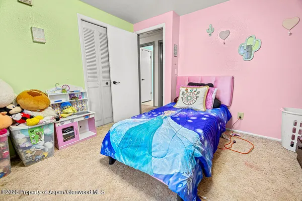 a bedroom with a bed and a dresser