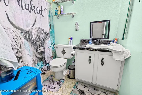 a bedroom with furniture and a wooden floor