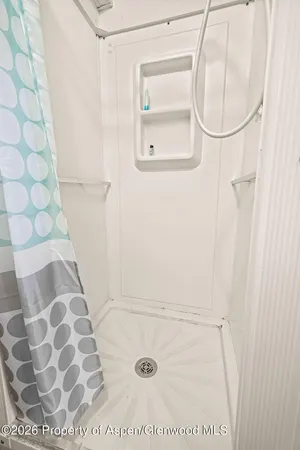 a bed sitting in a bedroom next to a cabinet