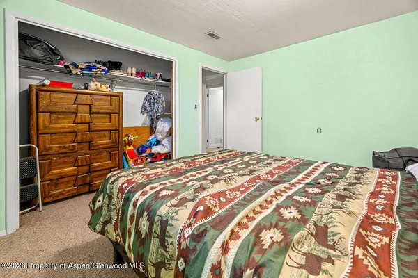 a bedroom with a bed and a chair