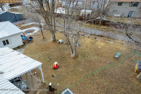 a view of a backyard with plants and outdoor seating