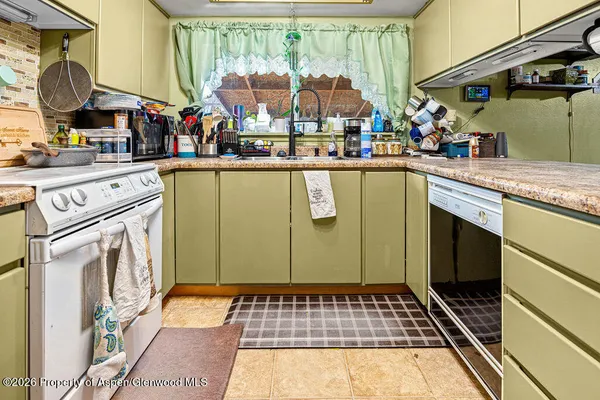 a view of counter top space with wooden walls