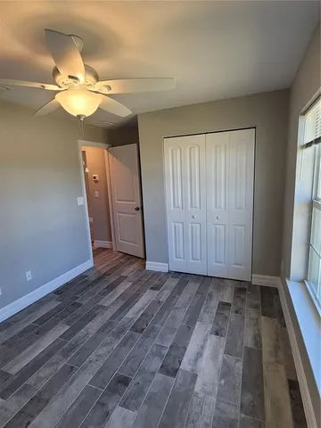 a spacious bathroom with a granite countertop sink toilet and shower