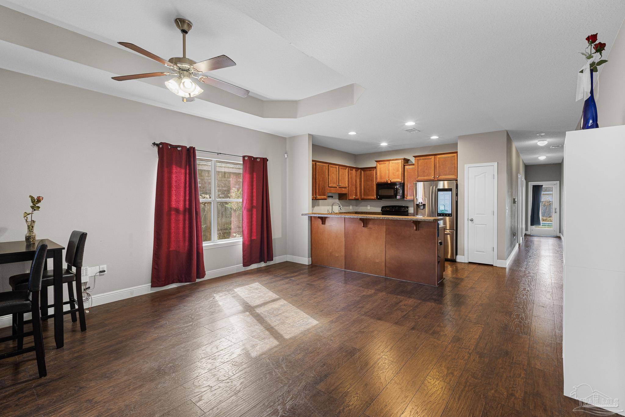 8855 Ridgebrook Court Pensacola, FL 32534 - Photo 13 of 37 a view of a kitchen with a refrigerator wooden floor and a kitchen