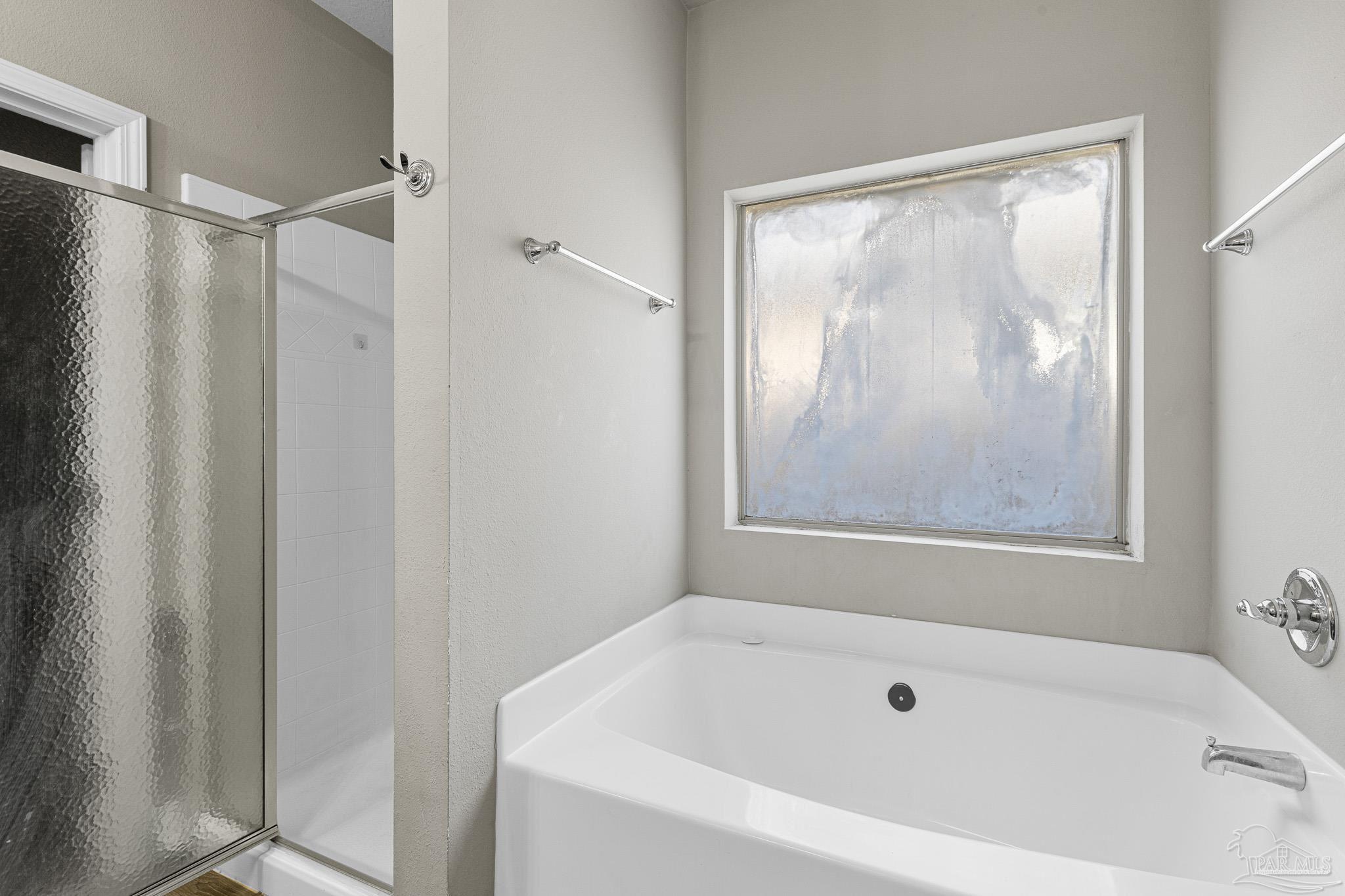 8855 Ridgebrook Court Pensacola, FL 32534 - Photo 22 of 37 a white bath tub sitting next to a shower