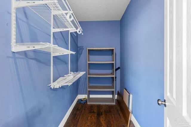 a view of walk in closet with empty racks