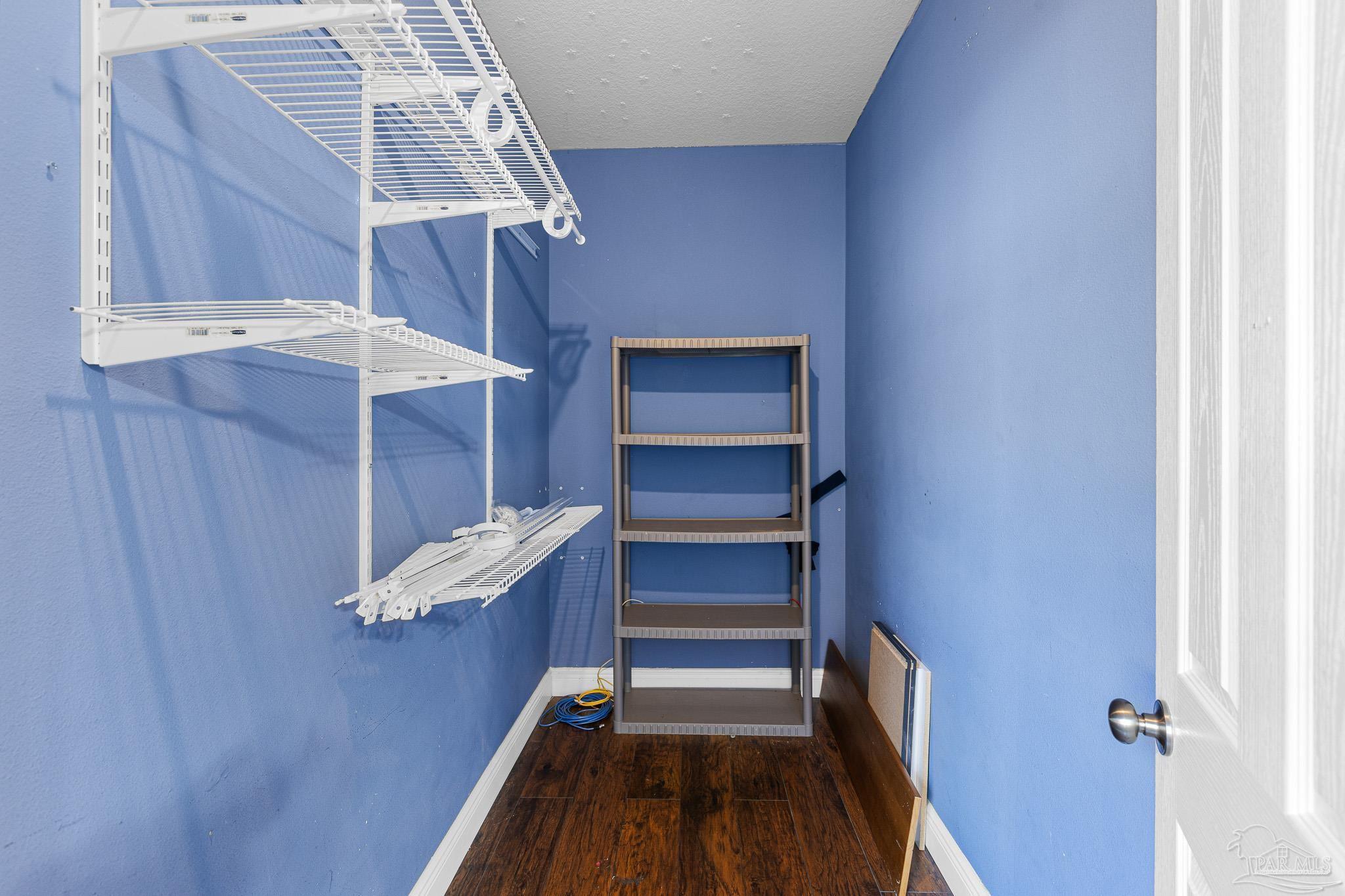 8855 Ridgebrook Court Pensacola, FL 32534 - Photo 25 of 37 a view of walk in closet with empty racks