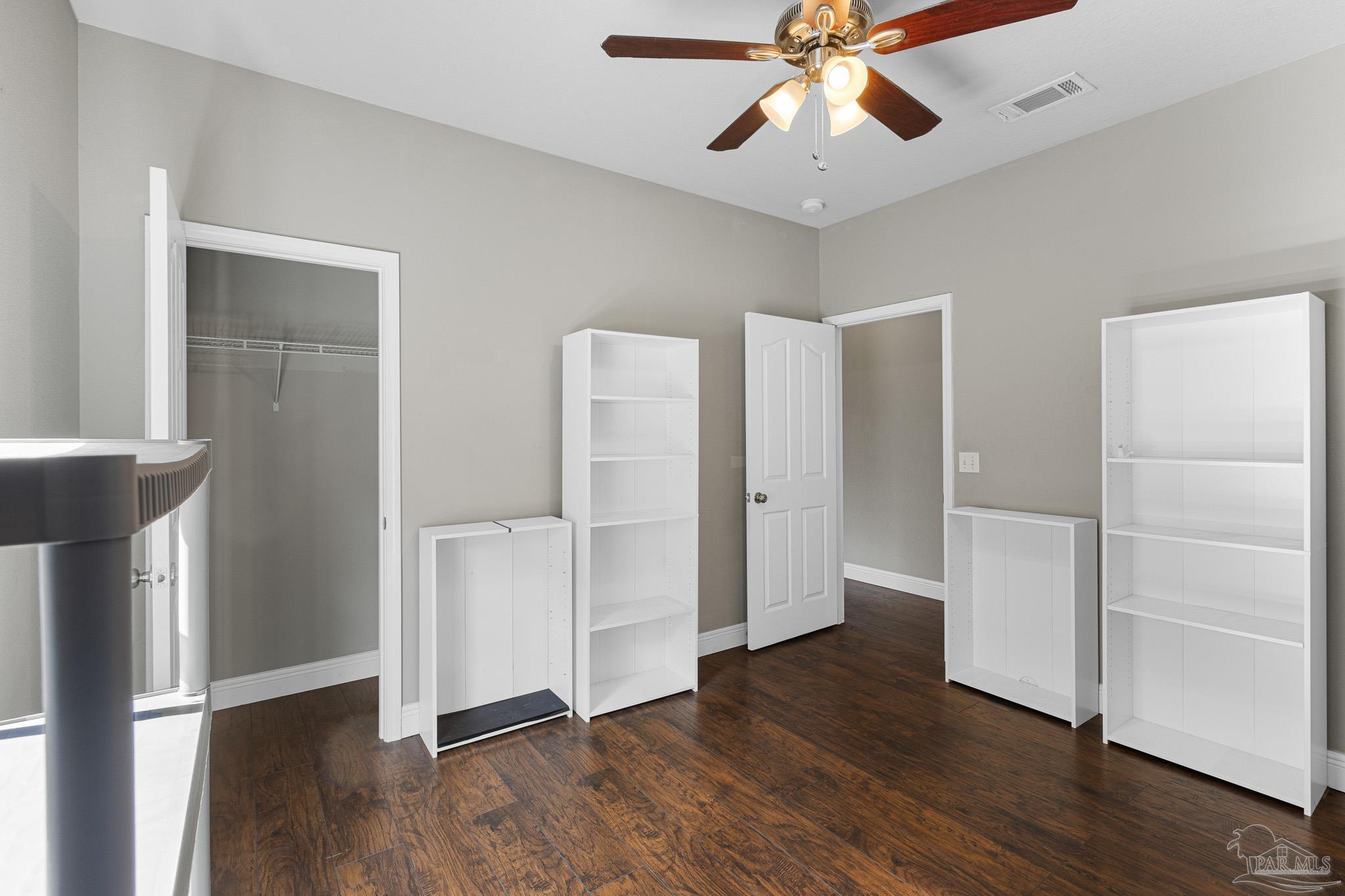 8855 Ridgebrook Court Pensacola, FL 32534 - Photo 27 of 37 a view of an empty room with wooden floor and a ceiling fan