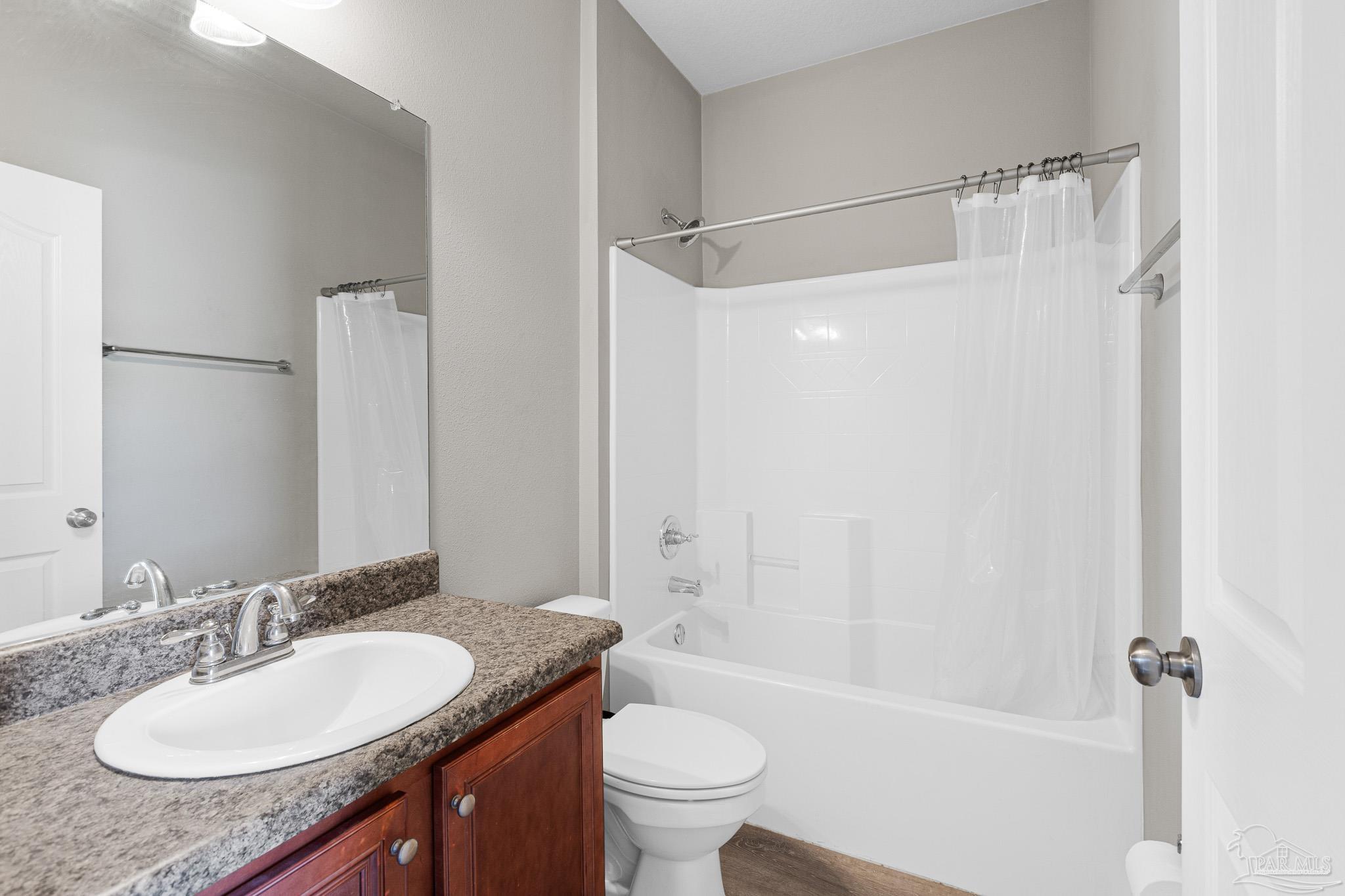 8855 Ridgebrook Court Pensacola, FL 32534 - Photo 31 of 37 a bathroom with a granite countertop sink toilet and shower