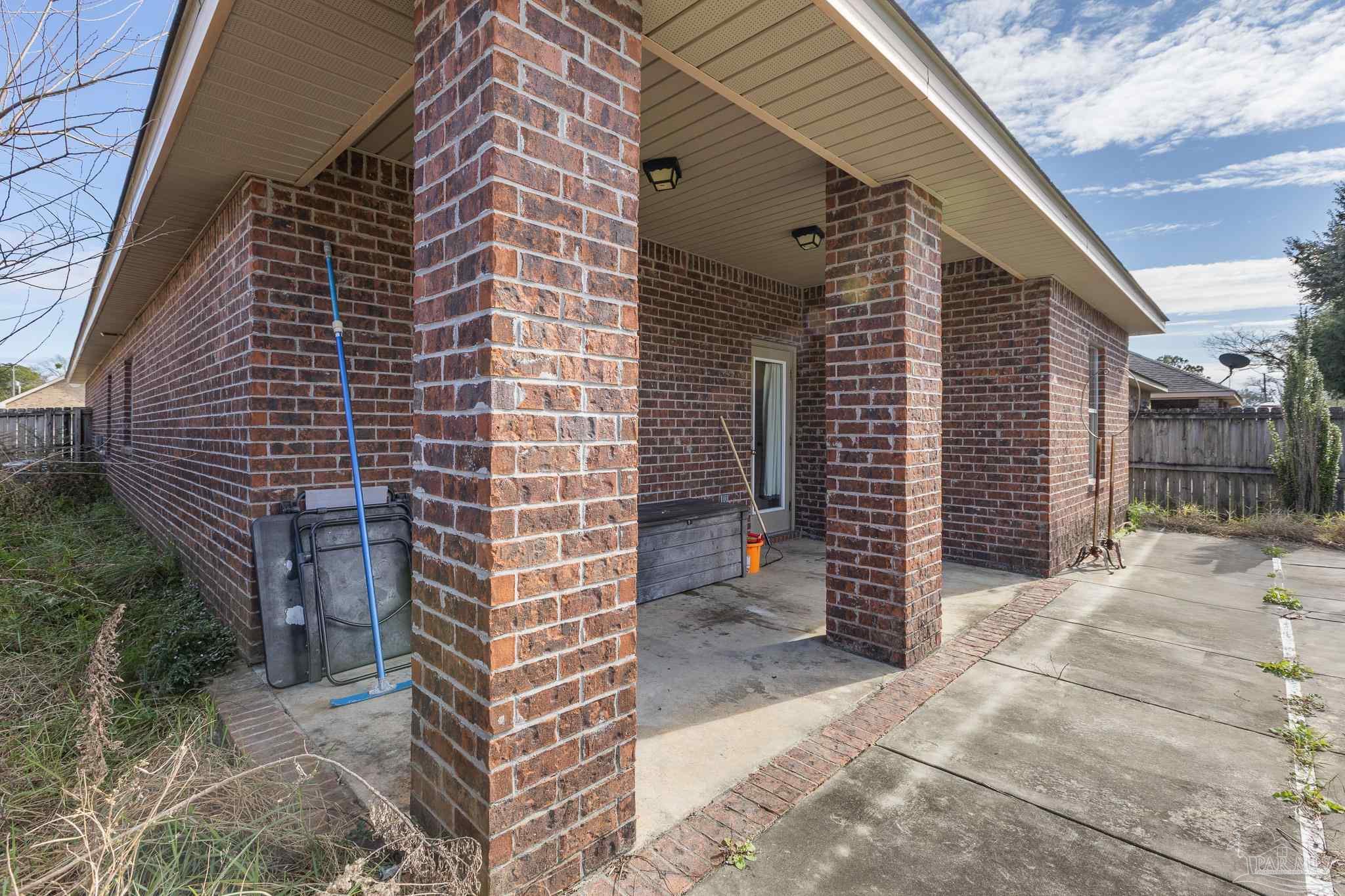 8855 Ridgebrook Court Pensacola, FL 32534 - Photo 37 of 37 a brick house with a yard and plants