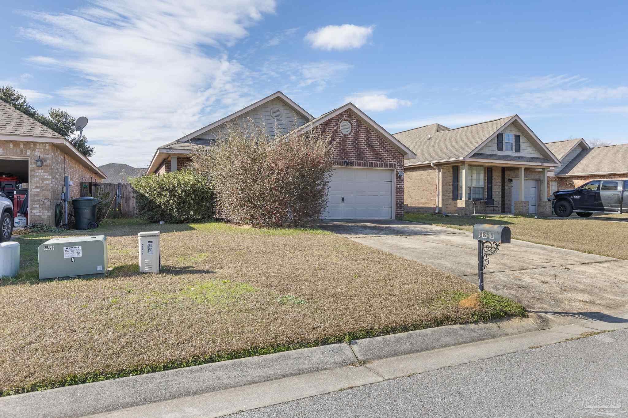 8855 Ridgebrook Court Pensacola, FL 32534 - Photo 6 of 37 a front view of a house with yard and garage