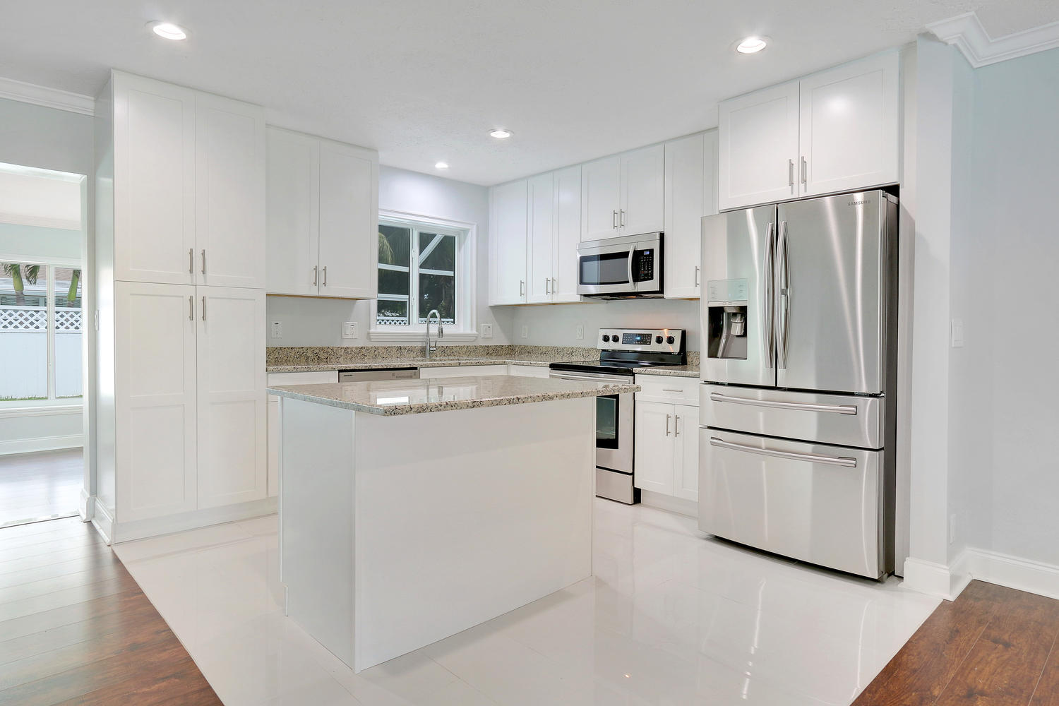 501 Harbour Road North Palm Beach, FL 33408 - Photo 5 of 20 a kitchen with white cabinets and stainless steel appliances