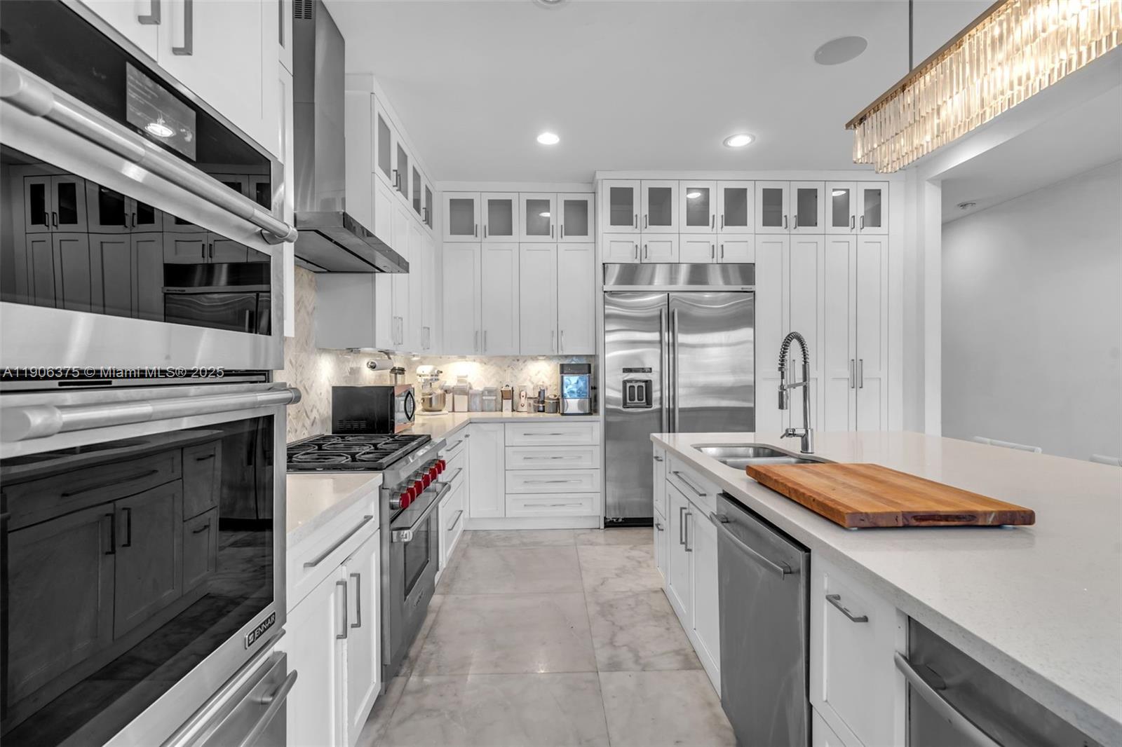 2085 Keystone Boulevard North Miami, FL 33181 - Photo 15 of 77 a kitchen with stainless steel appliances granite countertop a stove and a cabinets