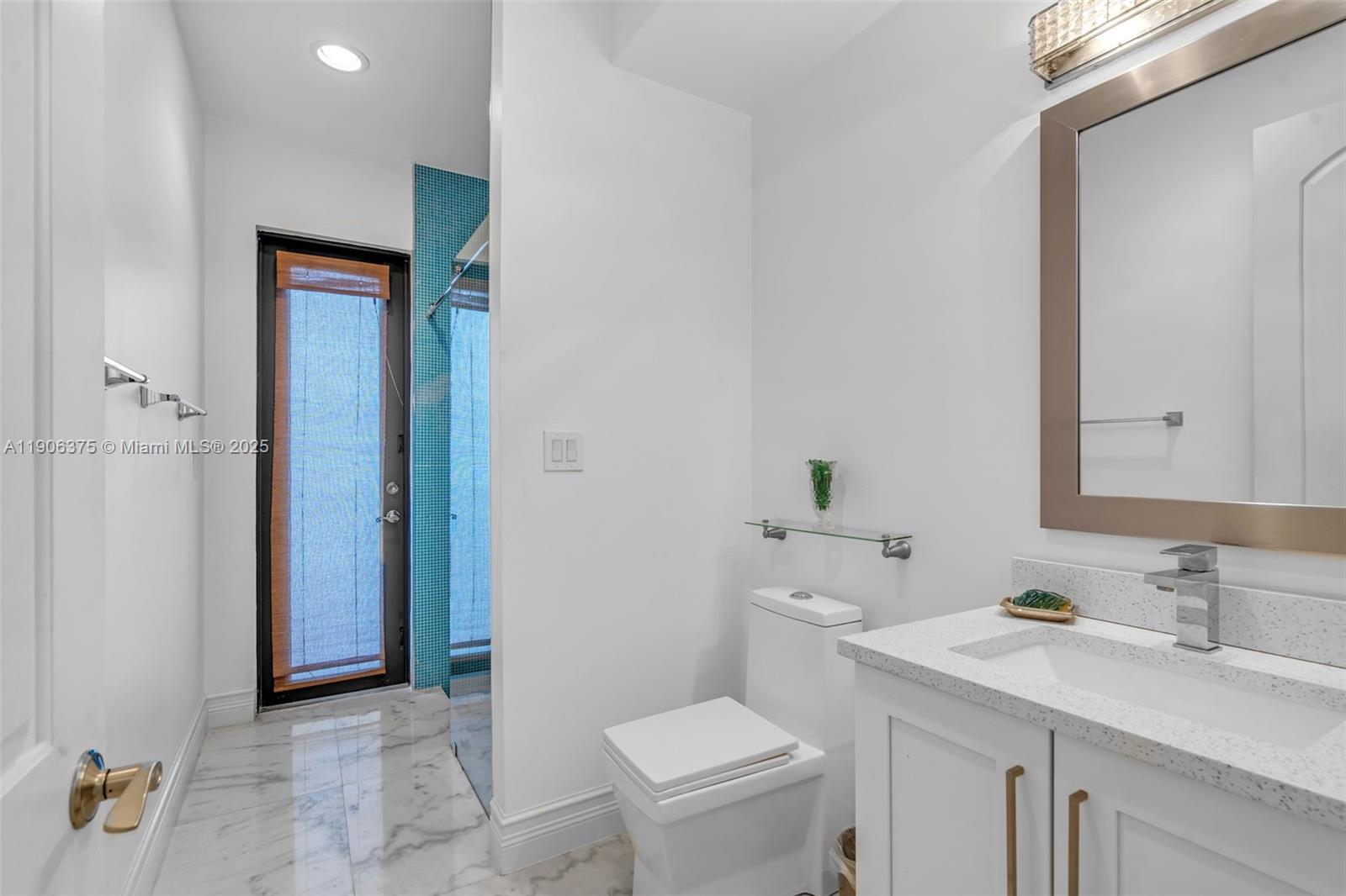 2085 Keystone Boulevard North Miami, FL 33181 - Photo 18 of 77 a bathroom with a granite countertop sink toilet and shower