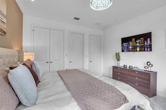 a large white bathroom with a large tub sink vanity and granite