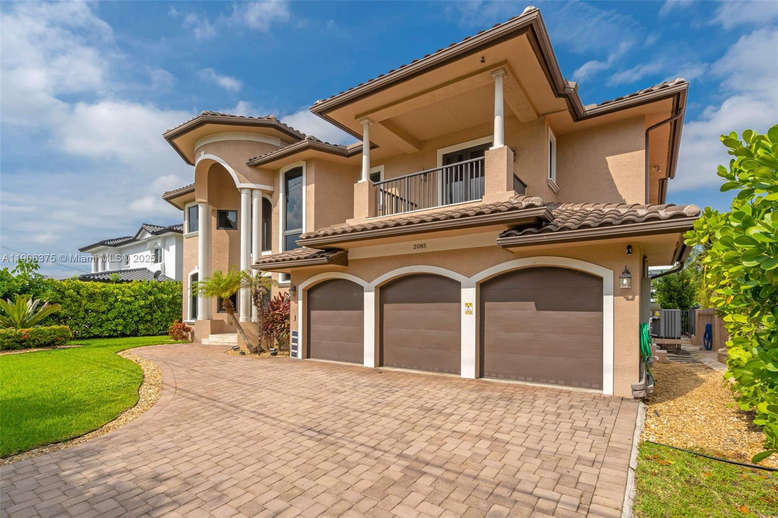 2085 Keystone Boulevard North Miami, FL 33181 - Photo 3 of 77 a front view of a house with garden