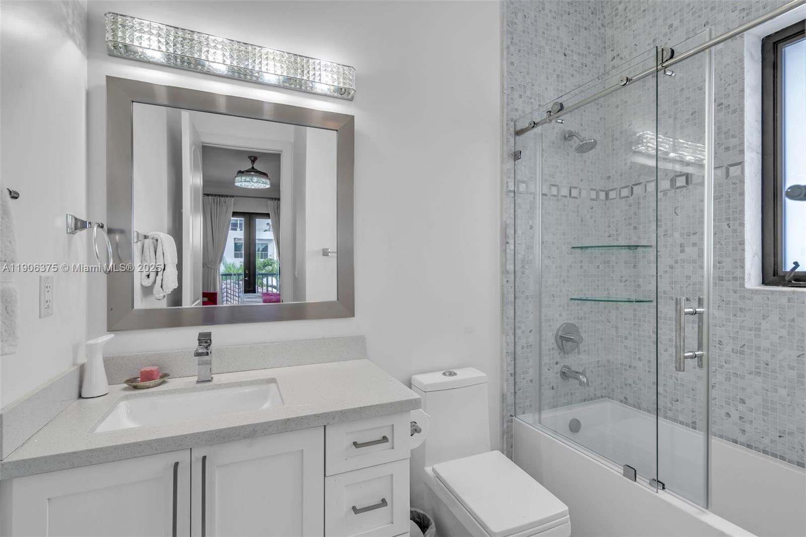 2085 Keystone Boulevard North Miami, FL 33181 - Photo 31 of 77 a bathroom with a bathtub shower sink vanity and toilet