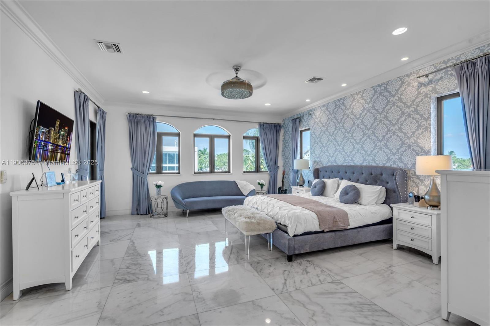 2085 Keystone Boulevard North Miami, FL 33181 - Photo 34 of 77 a spacious bedroom with a bed and window