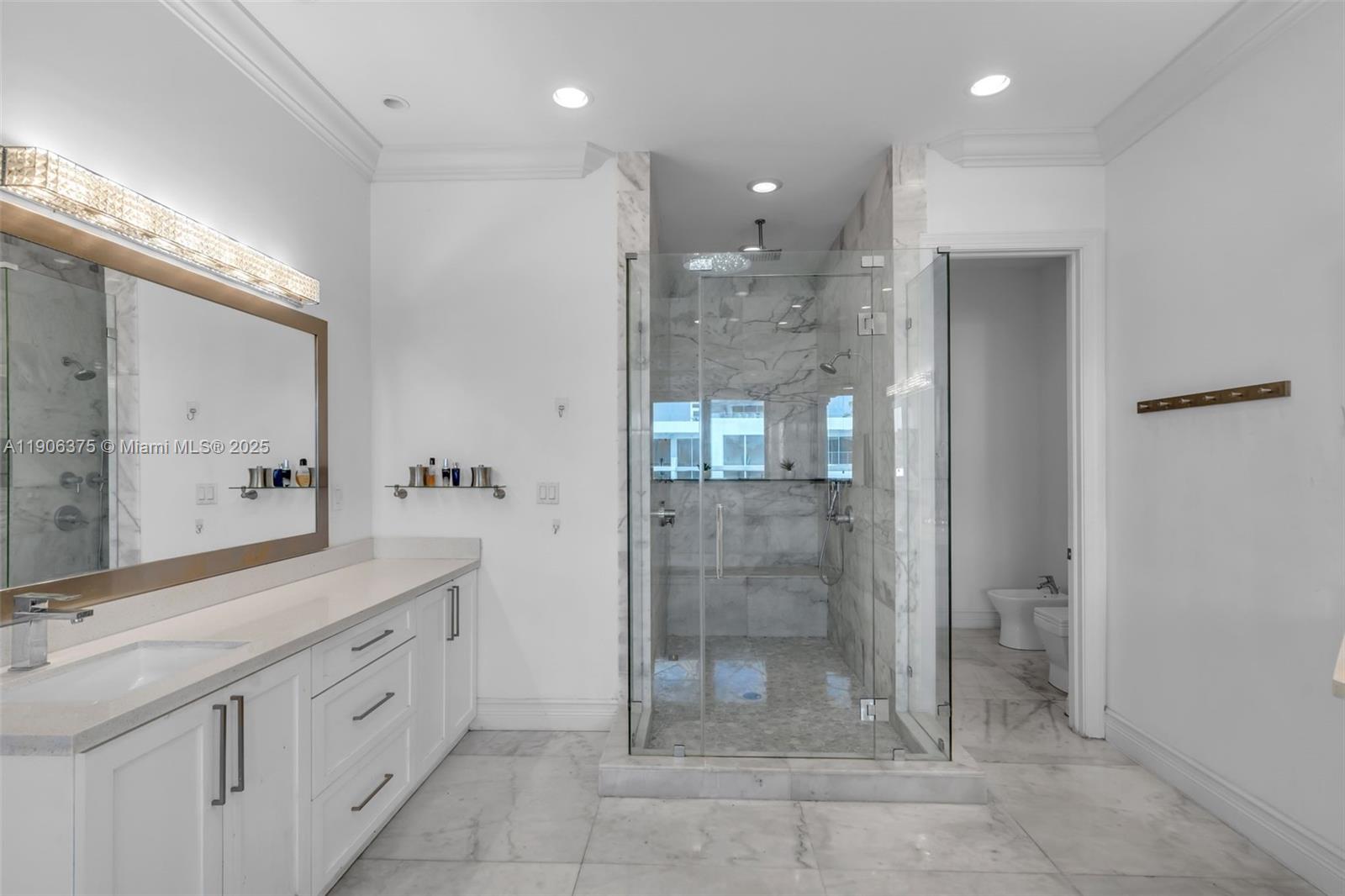 2085 Keystone Boulevard North Miami, FL 33181 - Photo 40 of 77 a bathroom with a shower sink and mirror