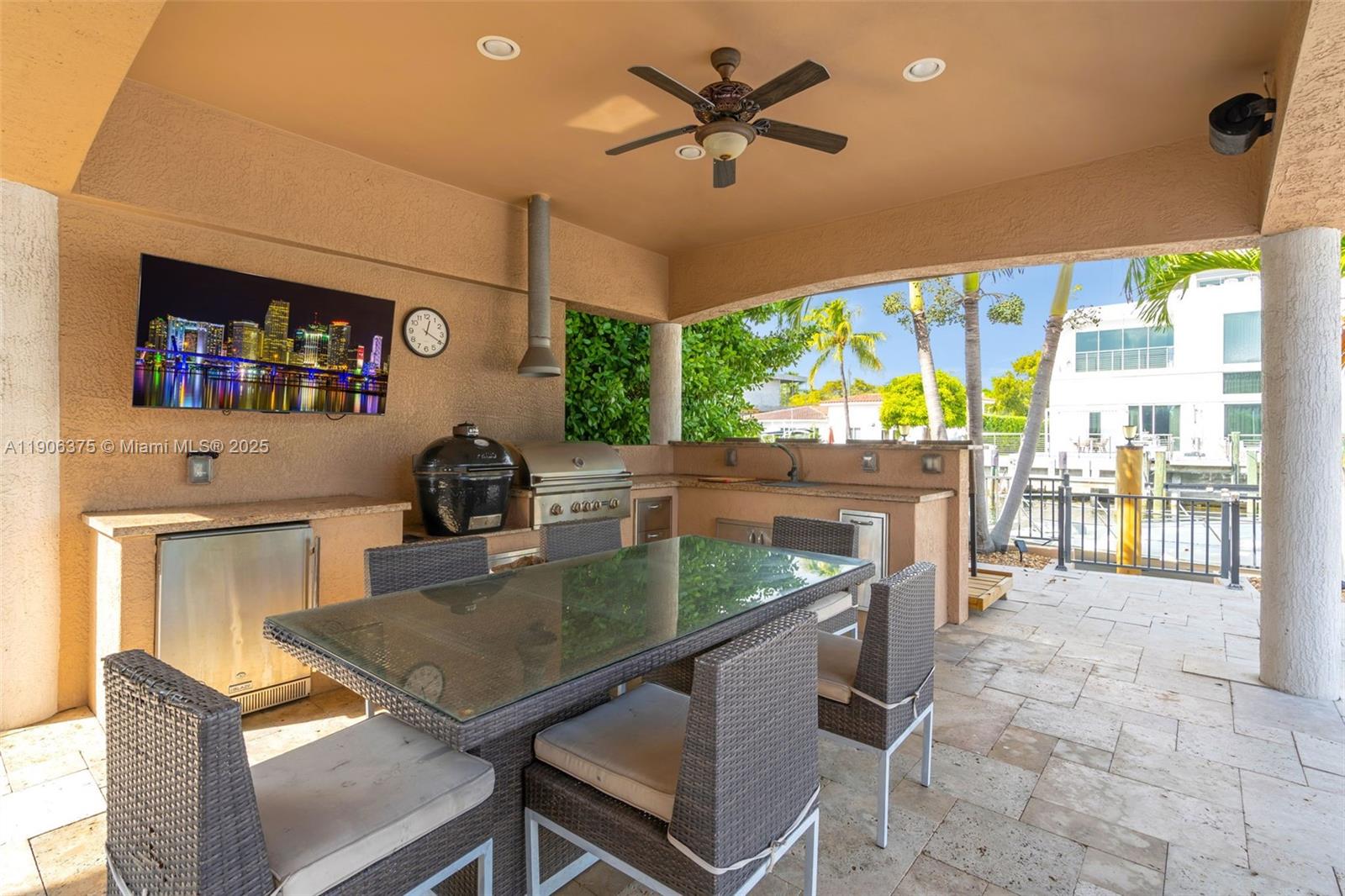 2085 Keystone Boulevard North Miami, FL 33181 - Photo 48 of 77 a kitchen with a stove a sink a counter top space and living room view