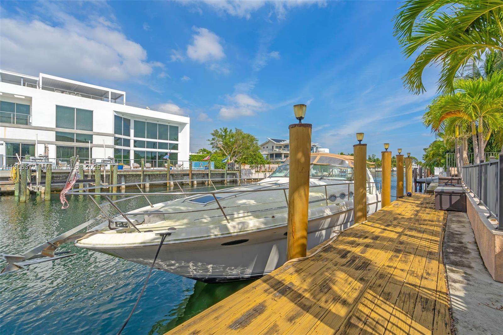 2085 Keystone Boulevard North Miami, FL 33181 - Photo 52 of 77 a view of a swimming pool with a patio