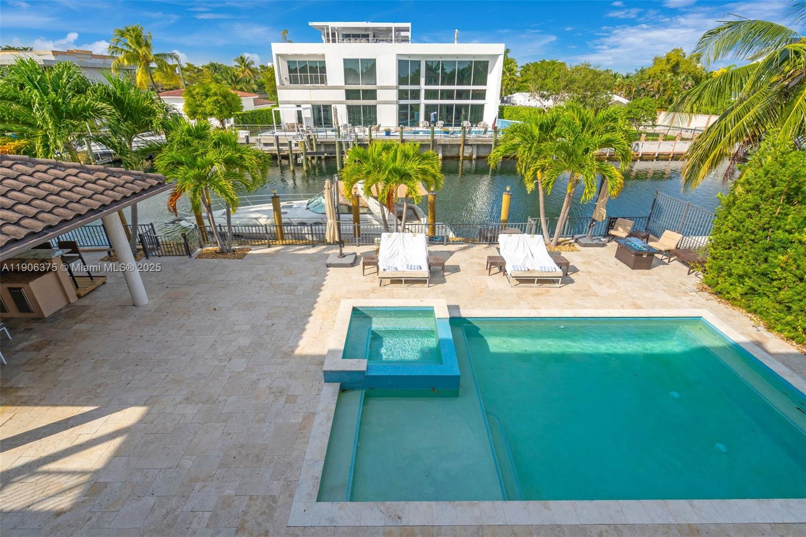 2085 Keystone Boulevard North Miami, FL 33181 - Photo 59 of 77 a view of a backyard with plants and a patio