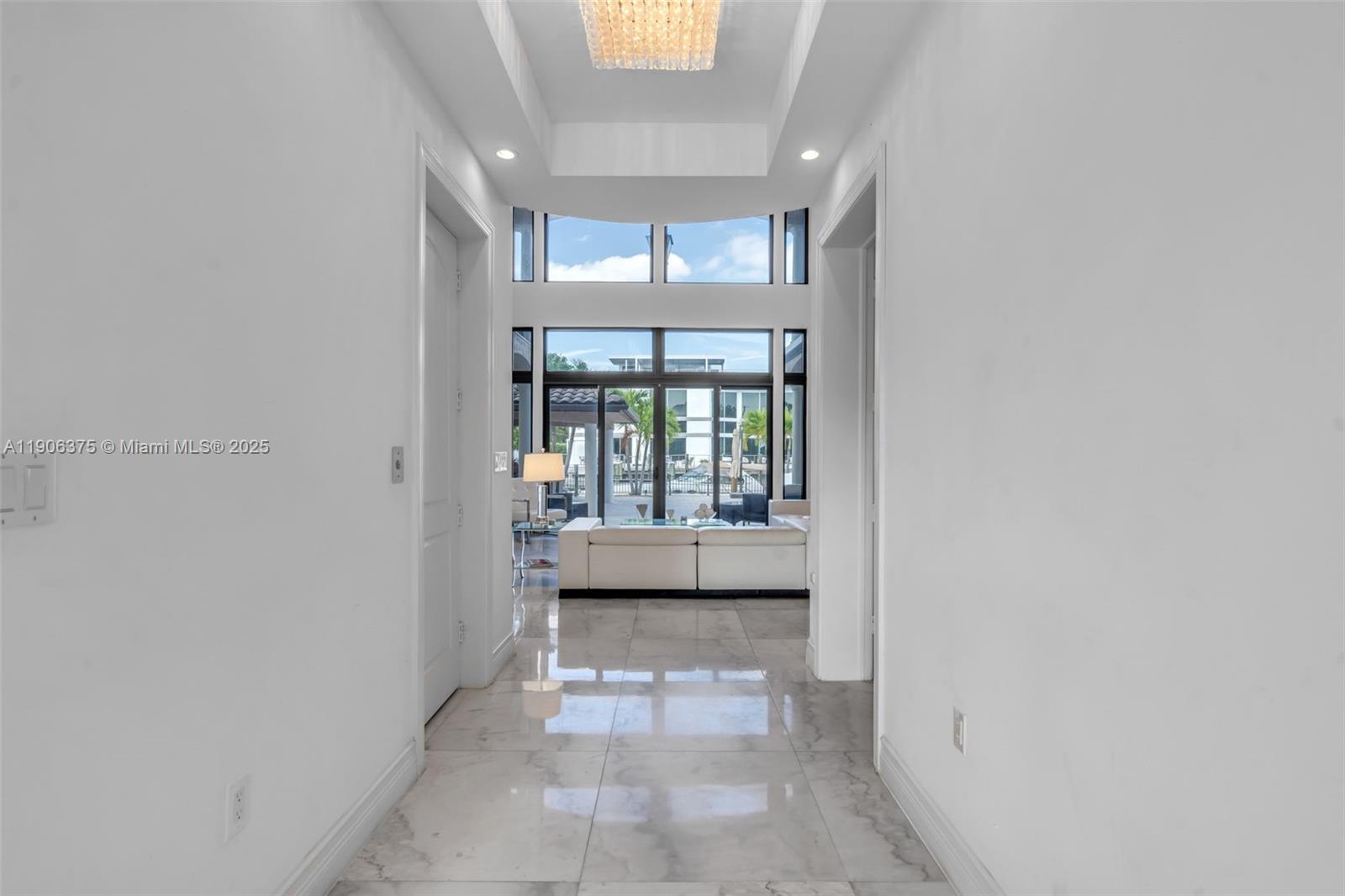 2085 Keystone Boulevard North Miami, FL 33181 - Photo 6 of 77 a view of a hallway with a chandelier