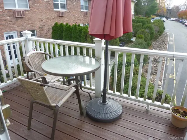 a view of balcony with wooden floor and outdoor seating