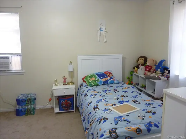 a bedroom with two beds and a dresser