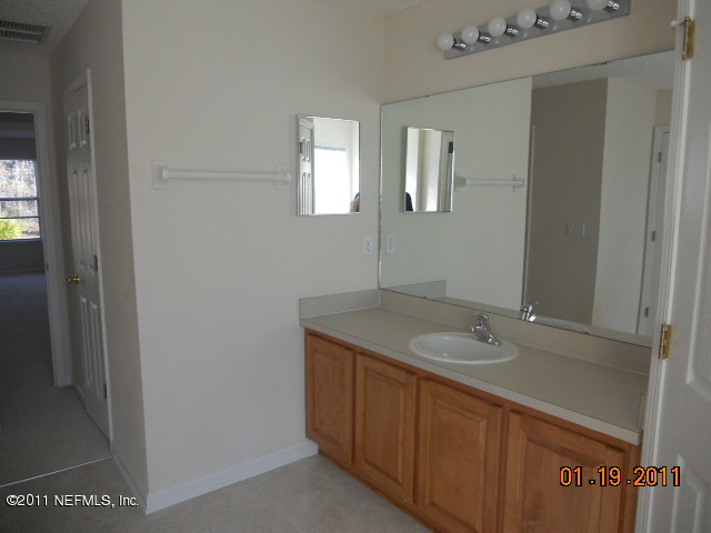 2911 Ravine Hill Drive Middleburg, FL 32068 - Photo 7 of 9 a bathroom with a granite countertop sink and mirror