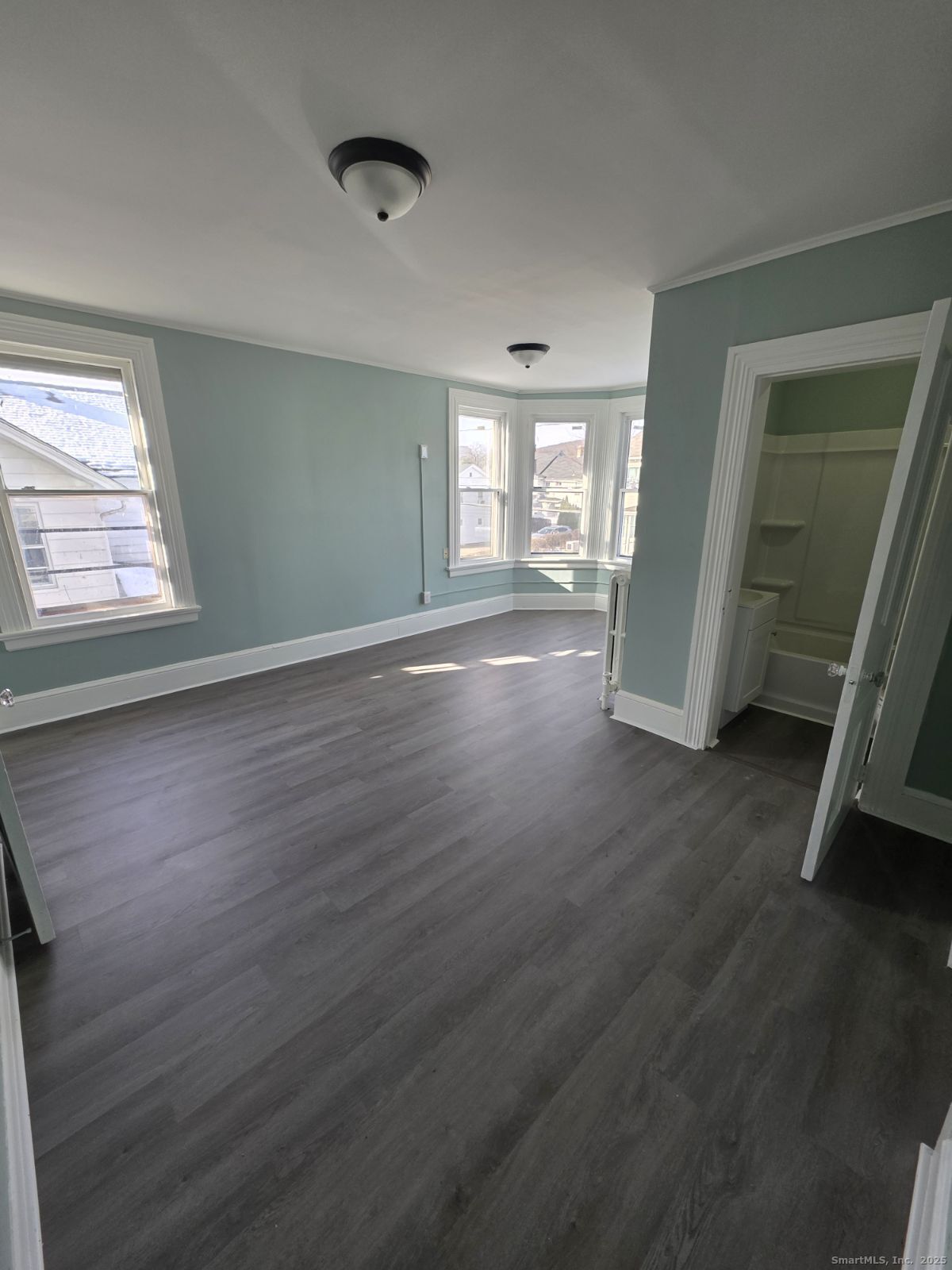 21 Pearl Street, Unit 2A Torrington, CT 06790 - Photo 2 of 4 a view of a room with wooden floor and window