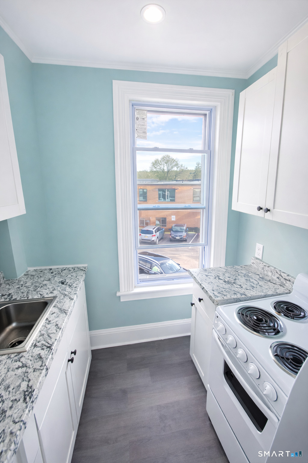 21 Pearl Street, Unit 2A Torrington, CT 06790 - Photo 4 of 5 a kitchen with a stove a sink and a refrigerator