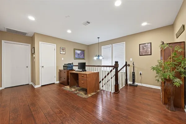 a view of a livingroom with furniture and hardwood floor